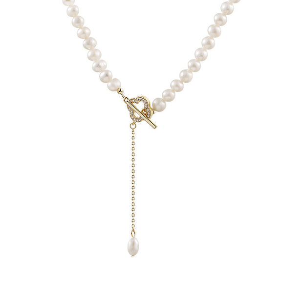 14k Gold Freshwater Pearl Necklace with genuine pearls in classic white or alluring purple, featuring an adjustable flat gold chain for versatile wear.